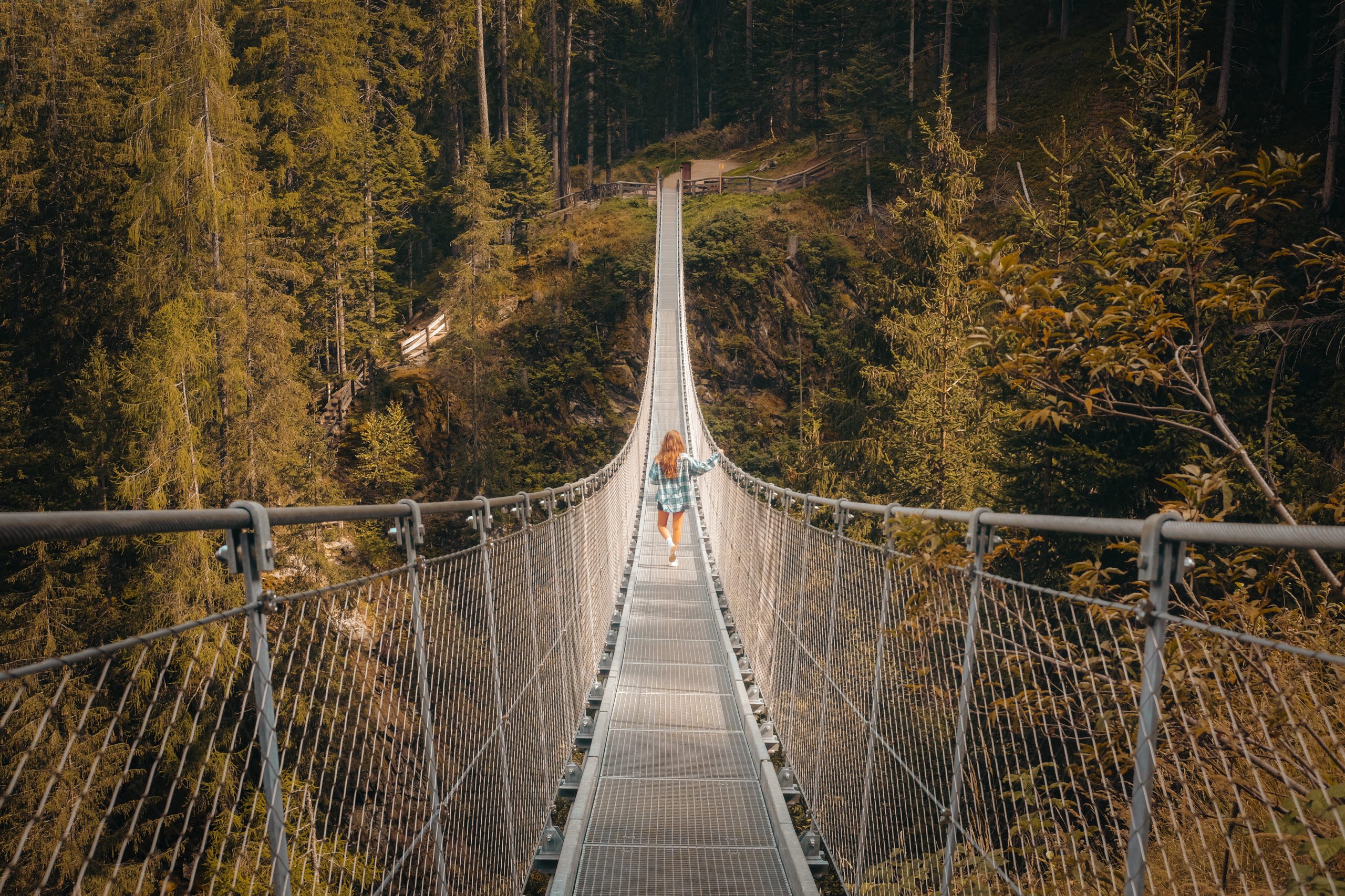 A person on a self-anchored suspension bridge